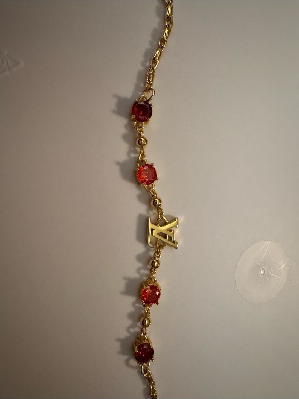 Gold-Tone Bracelet with Red Gem Accents